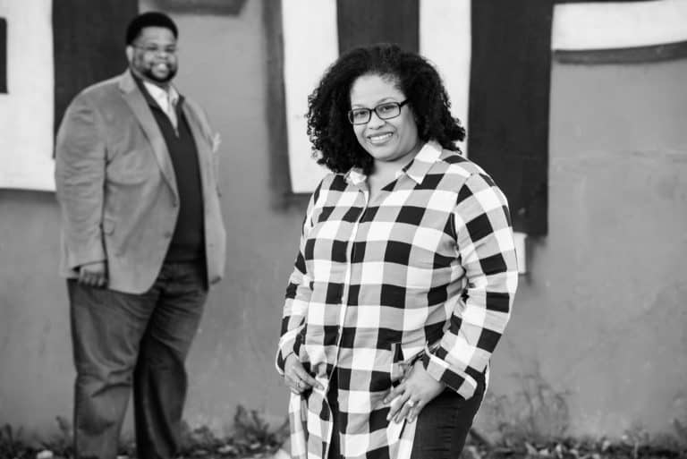 Photography Packages & Pricing Zina smiling with El in the background at Cooper Young.