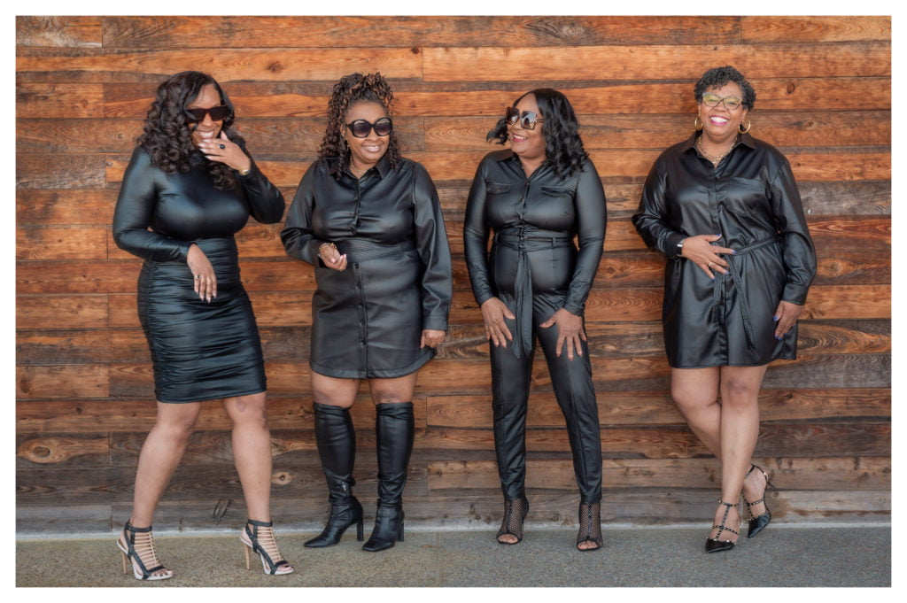 a group of women in black dresses